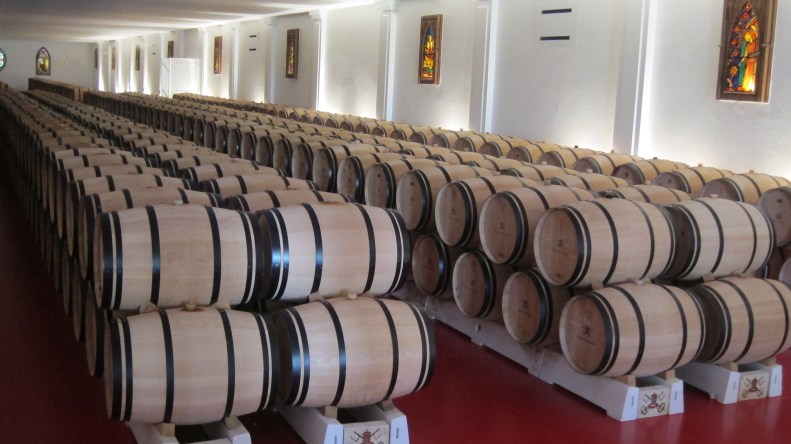 wine aging in oak casks. notice the stained glass windows.