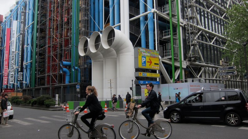 centre pompidou with 2 bike share folks riding by. every town we were in had bike sharing already. let's go nycity!